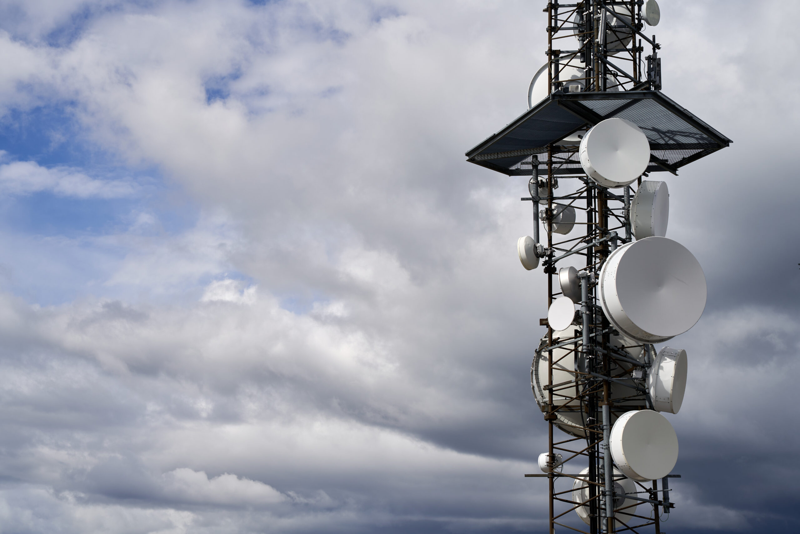 Telecommunications towers against cloudy sky background A telecommunications towers against cloudy sky background